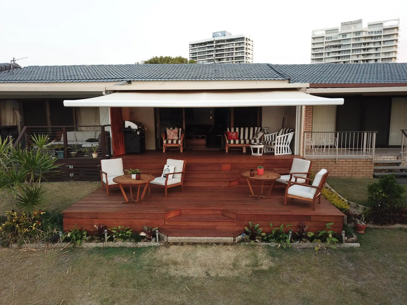 After: finished two-level hardwood deck with steps and outdoor furniture