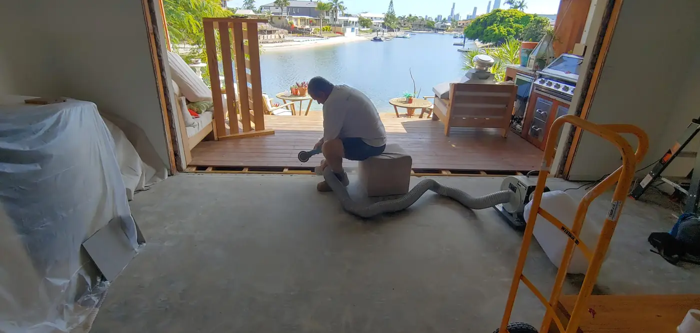 Sanding the boards of a canal-front deck