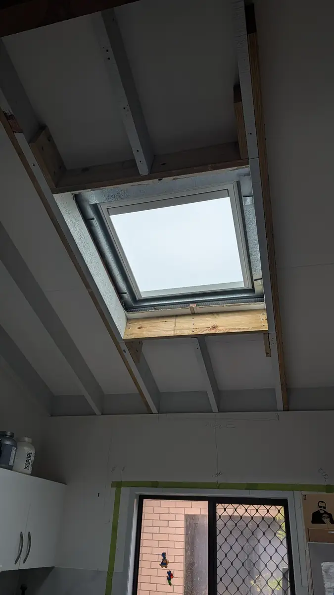 Timber framing around a new skylight opening in a raked ceiling