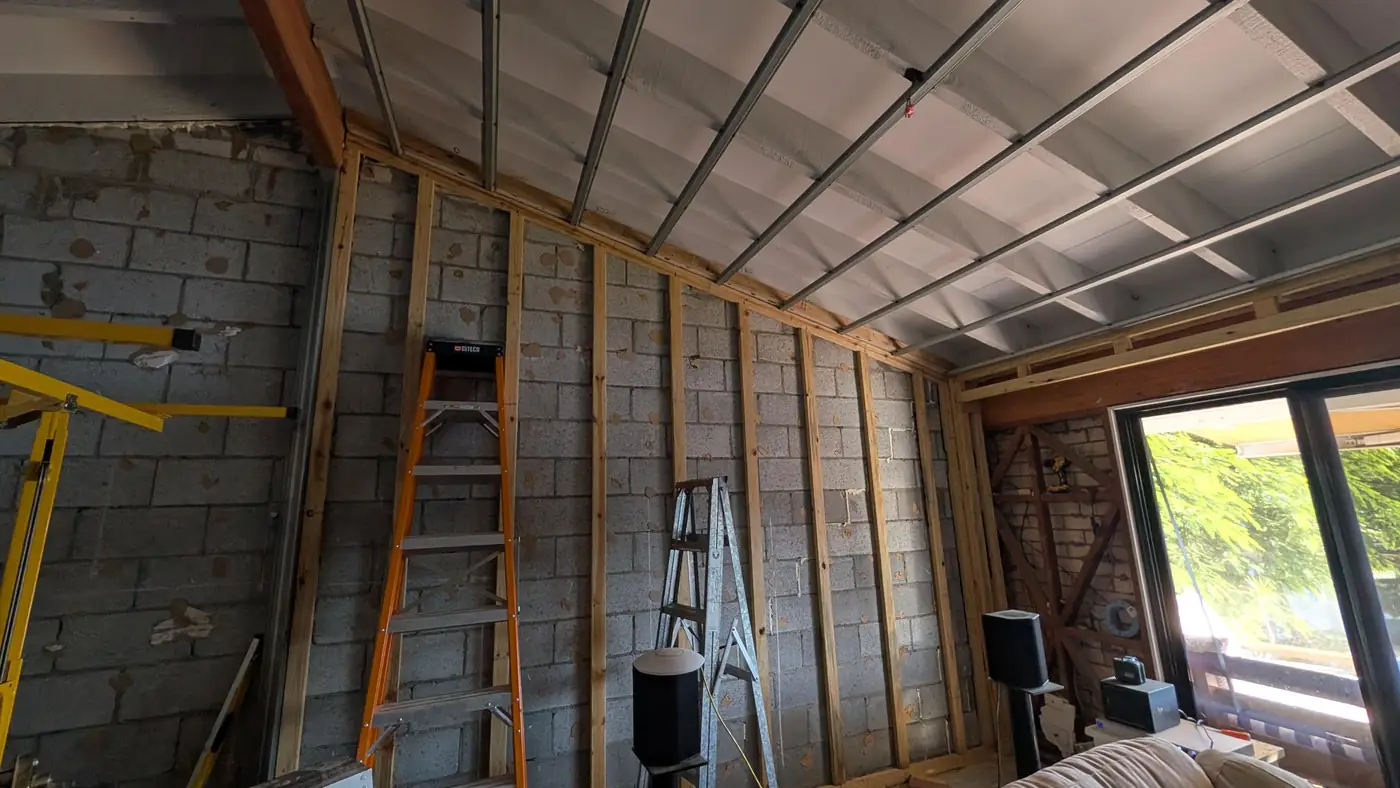 New timber wall framing over blockwork, with ceiling battens