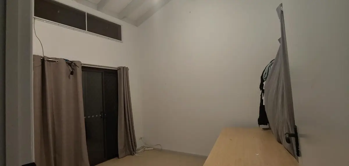Before: empty room with a high raked ceiling