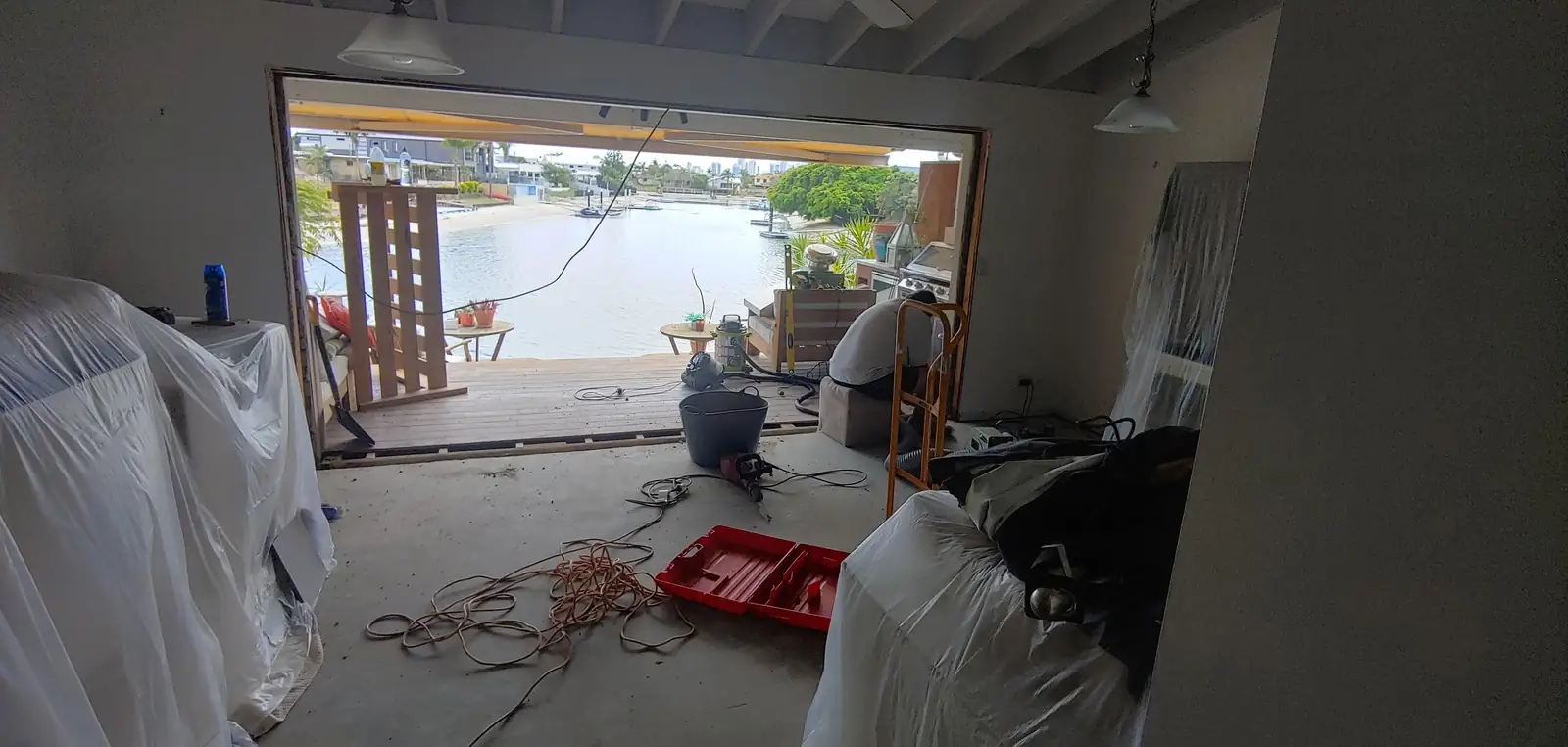 A wall opened up onto a canal-front deck during a renovation